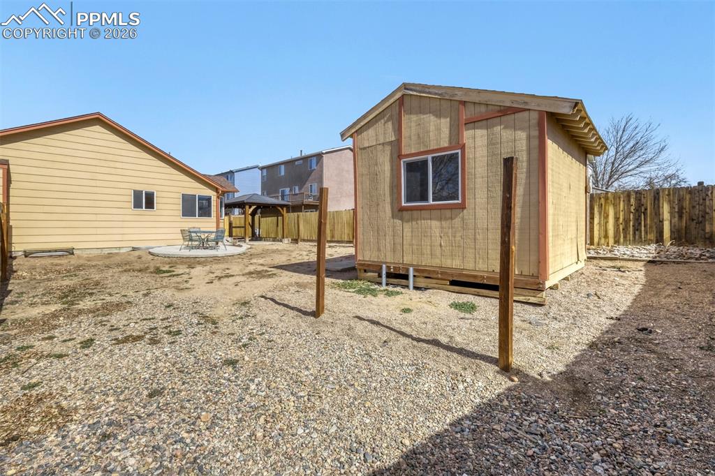 Image 26 of 31: RV parking in the rear yard with gate