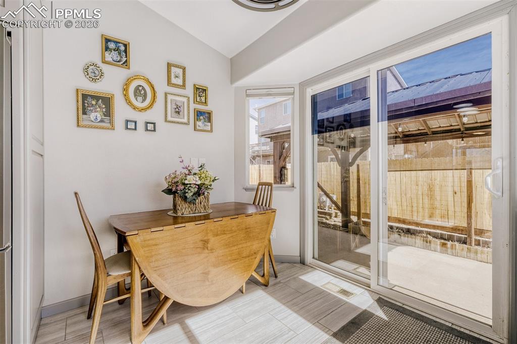 Image 7 of 31: Eat in Kitchen- walks out to outdoor living area