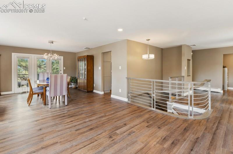 Image 15 of 47: Great room concept dining room, living room and entry with custom metal rai