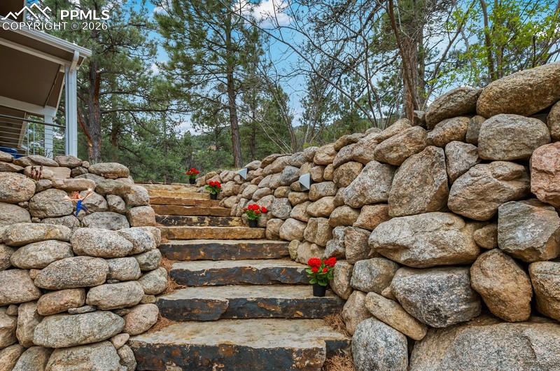 Image 2 of 47: Stunning new custom entry with multi level flowerbeds!