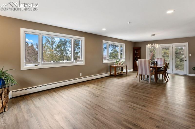 Image 20 of 47: Second great room concept with living room and dining room and walk out to 