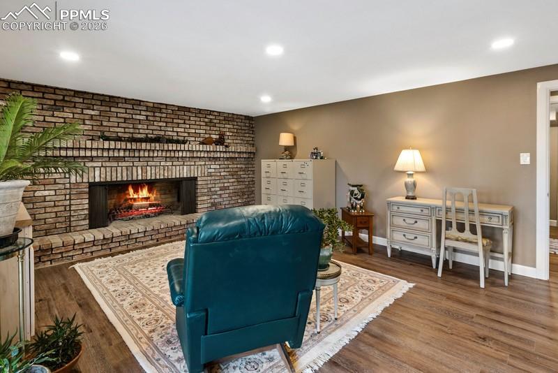 Image 28 of 47: Bedroom or rec room with awesome wood fireplace and walk tou to covered pat