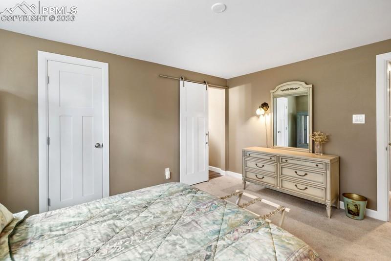 Image 32 of 47: Suite with walk in closet and custom barn door to a private bathroom!
