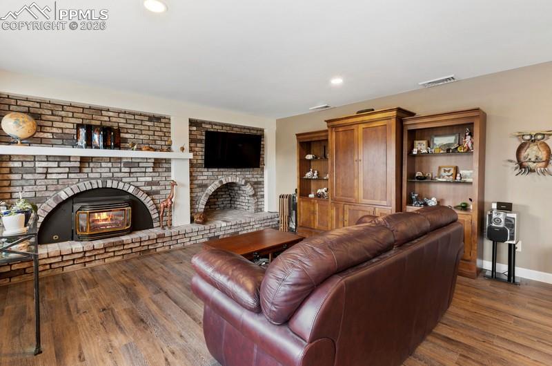 Image 8 of 47: With full wall brick gas fireplace insert. 