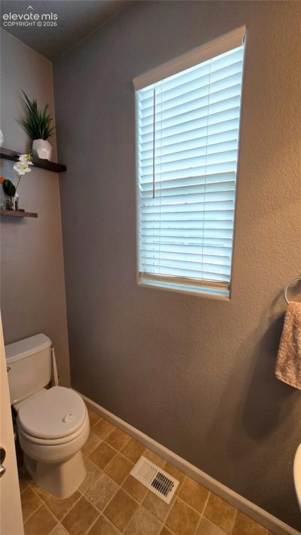 Image 11 of 21: 1/2 bath at front of house
