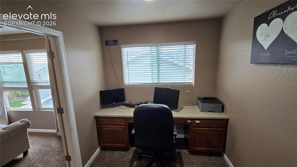 Image 13 of 21: Built in desk at top of stairs on upper level