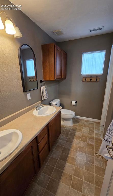 Image 16 of 21: Primary Bathroom off bedroom with walk in closet