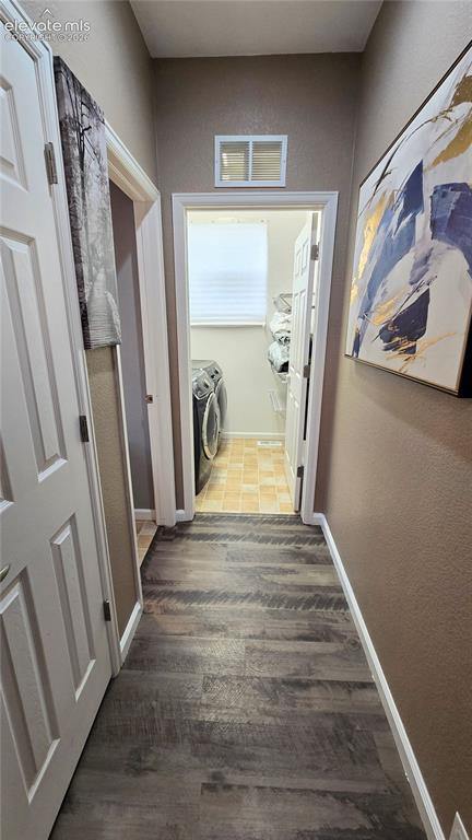 Image 9 of 21: Hallway off entryway to laundry and 1/2 bath