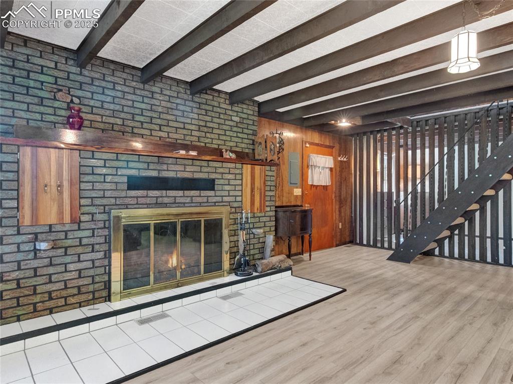 Image 2 of 43: Very cozy with this large fireplace and lots of room as you come in the fro