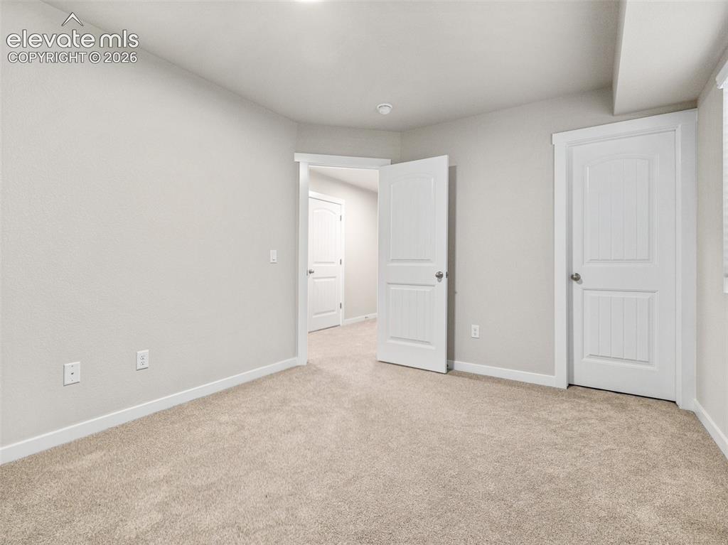 Image 25 of 30: Neutral-toned wall paint, white trim, and light-colored carpeting throughou