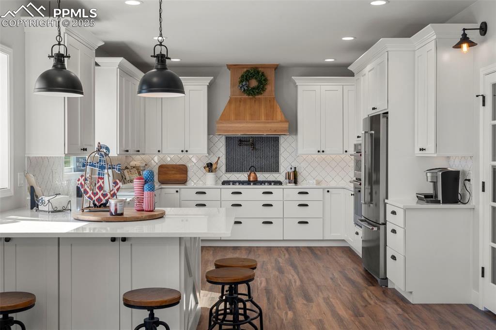 Image 12 of 50: Updated kitchen complete with quartz countertops , SS appliances, gas range