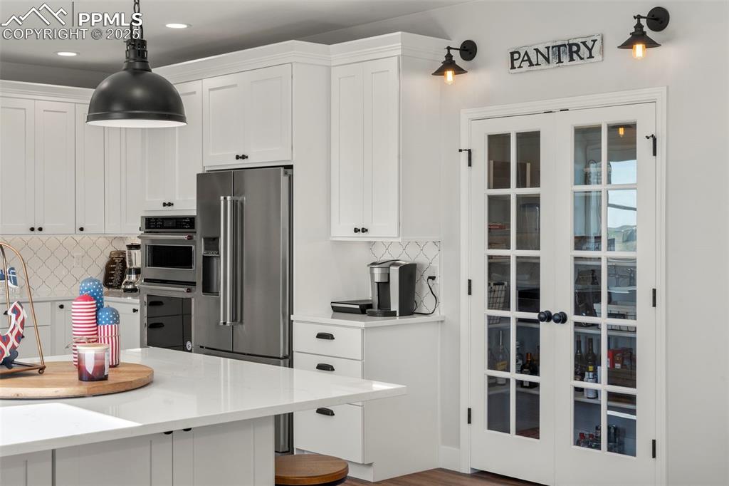 Image 16 of 50: French doors to the walk in pantry