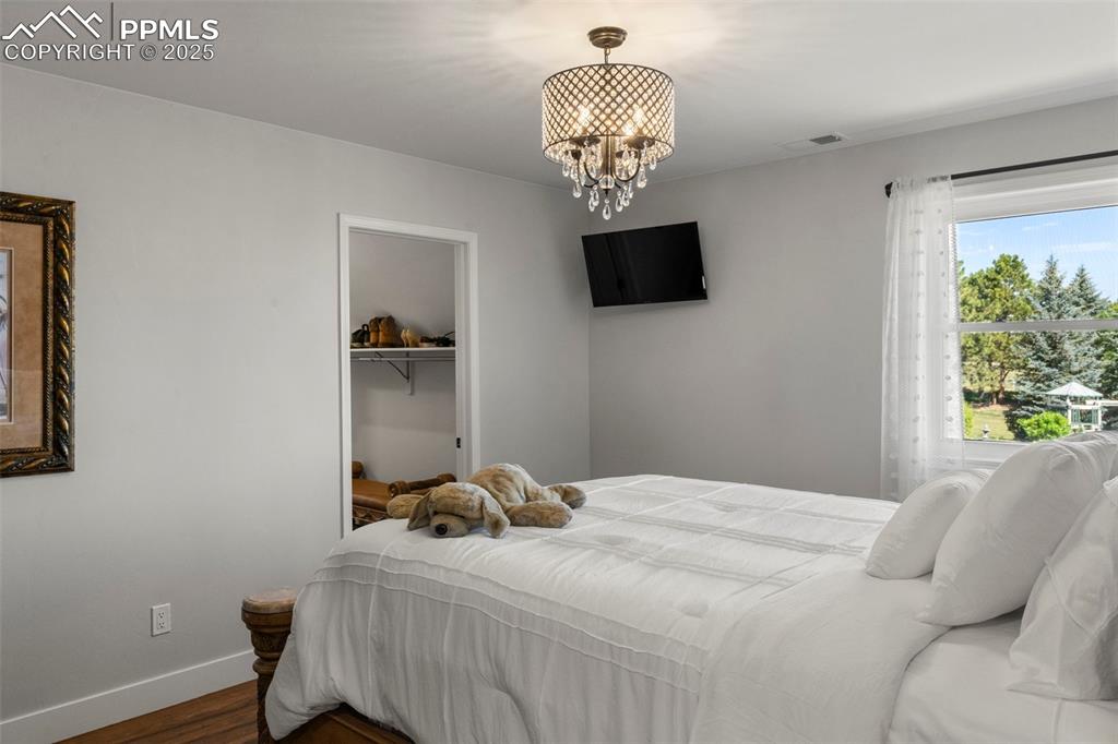 Image 29 of 50: Upstairs bedroom with walk in closet and attached 3/4 bath.