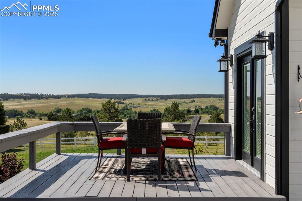 Image 36 of 50: From the dining room you walk out to this lovely deck with stunning country