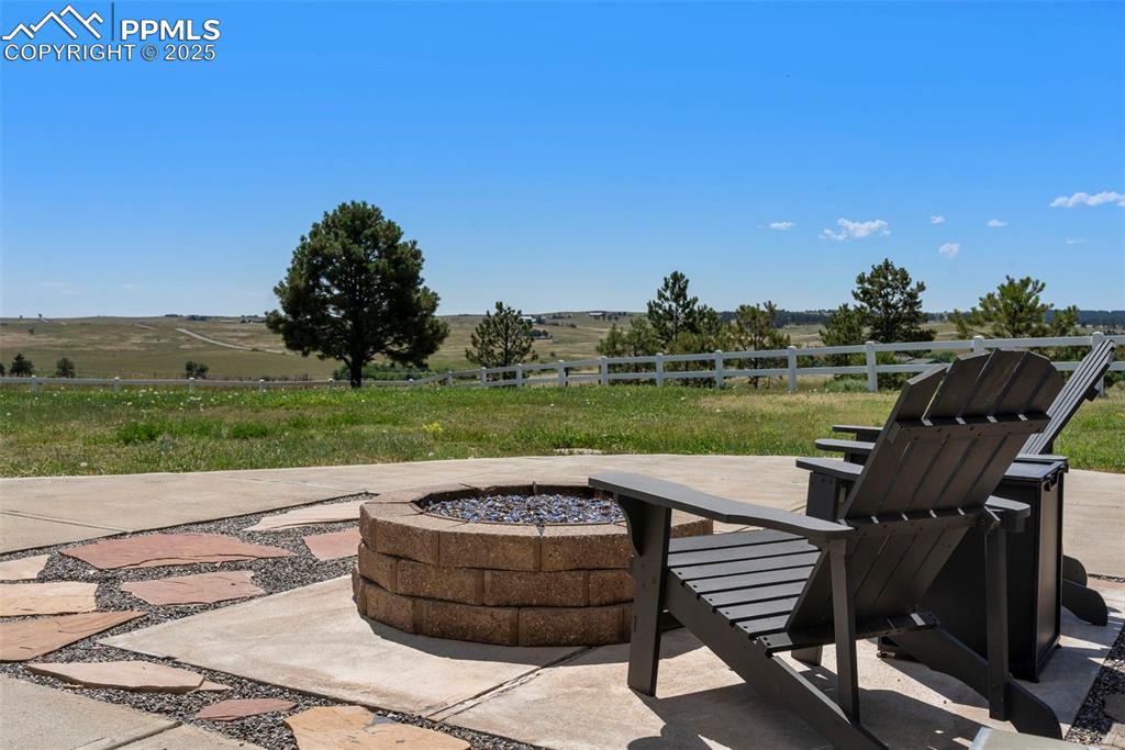 Image 41 of 50: Just off the walk out basement is fire pit and flagstone patio. 