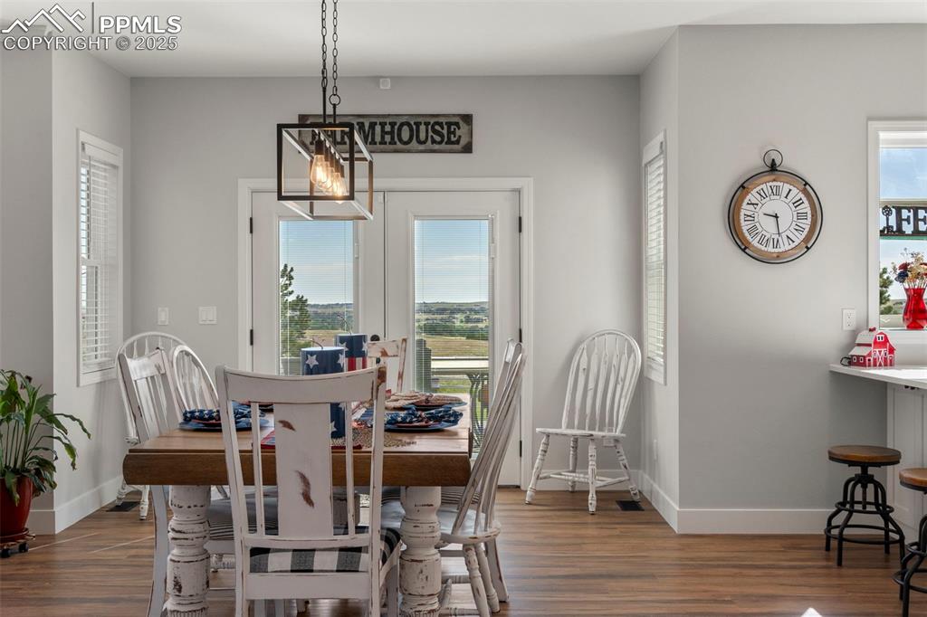Image 8 of 50: Dining room is open and bright. Walk out to back deck.