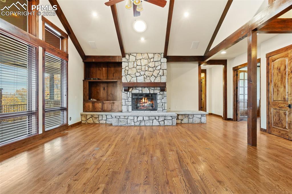 Image 17 of 50: The impressive stone fireplace is the focal point of the great room.