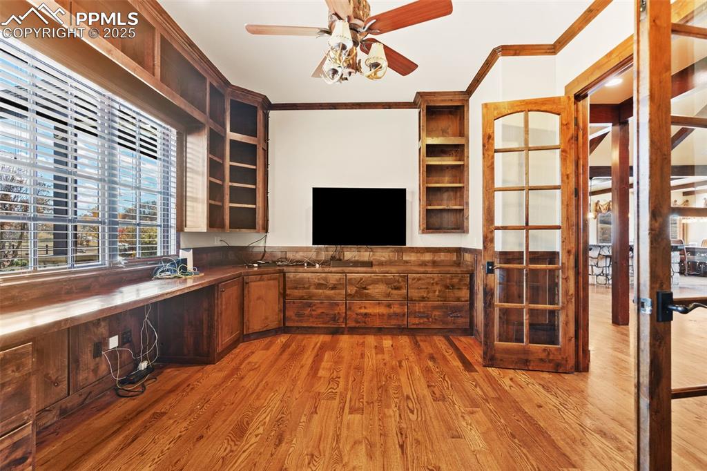 Image 19 of 50: This attractive main level office offers all the built-in cabinets and shel