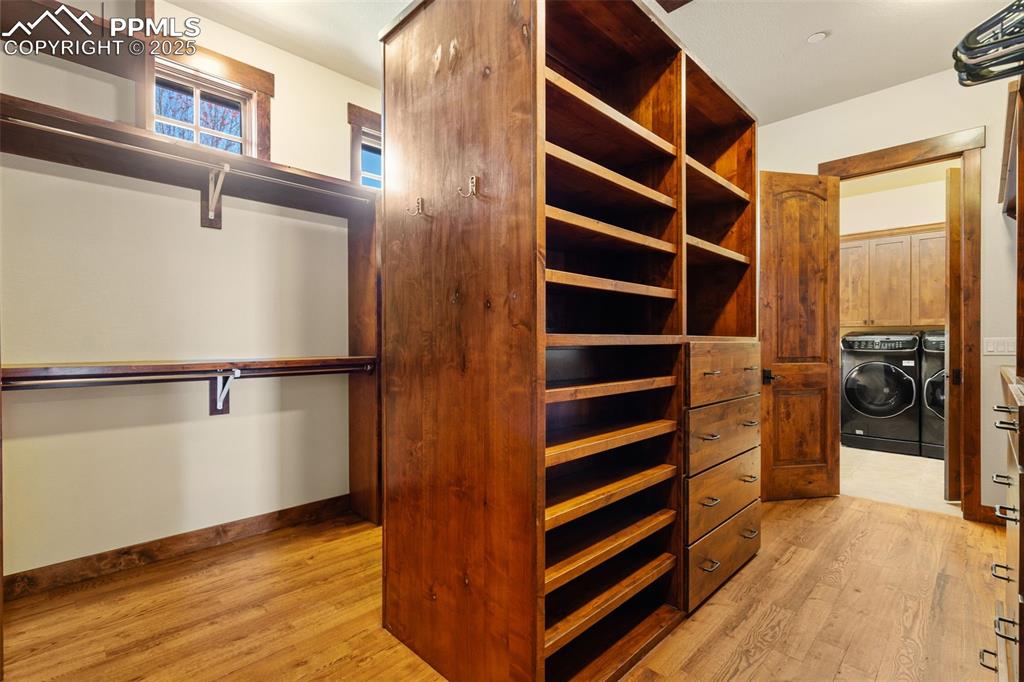 Image 25 of 50: This is one amazing primary suite walk-in closet with an adjacent laundry r