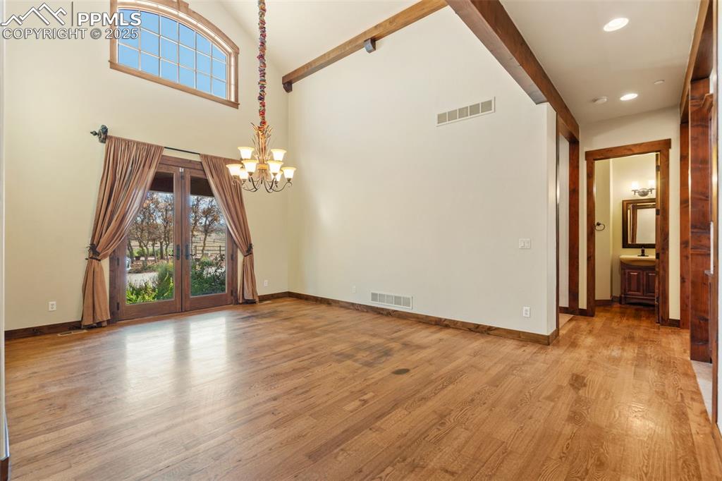 Image 29 of 50: The expansive formal dining room with uplighting is open and bright with ou