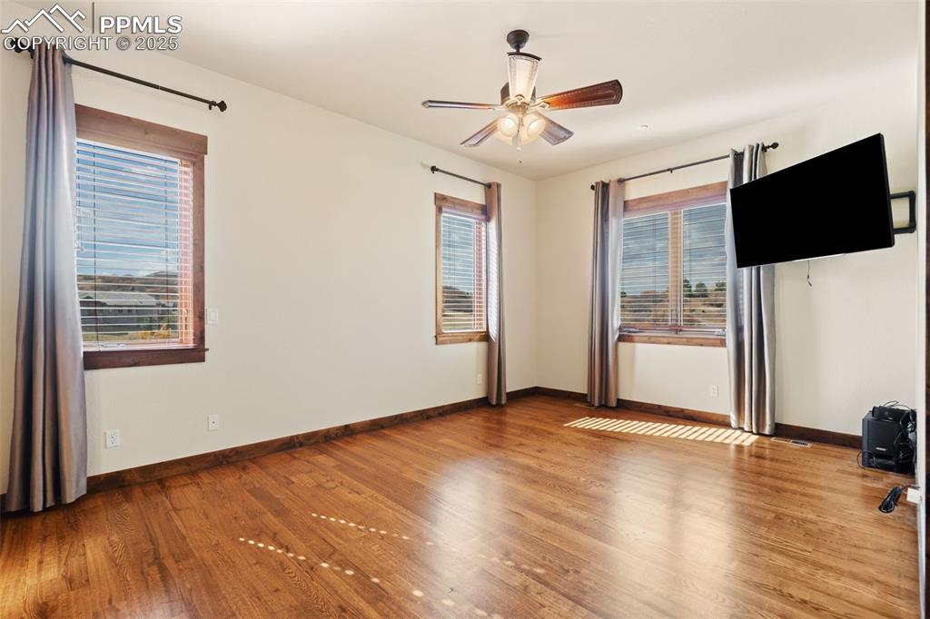 Image 33 of 50: Bedroom 2 on the main level features a walk-in closet and adjoining 3/4 bat