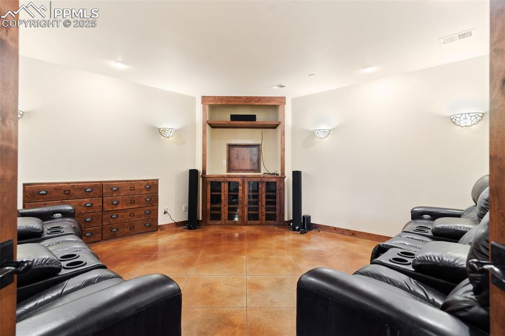 Image 42 of 50: Enjoy family time in this great theater room with built-ins and a BONUS...