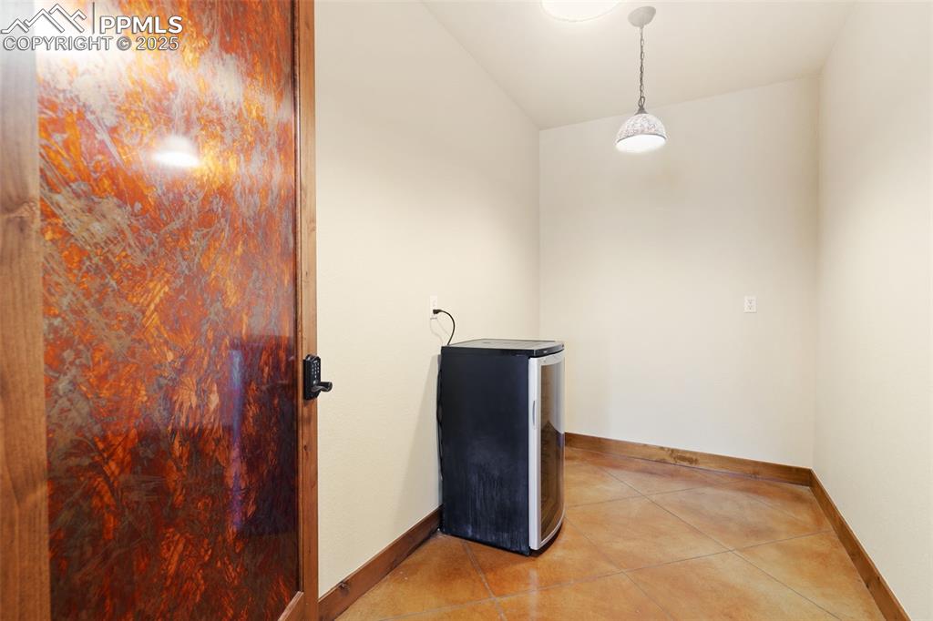 Image 43 of 50: This home even boasts a climate-controlled wine room with a 32-bottle wine