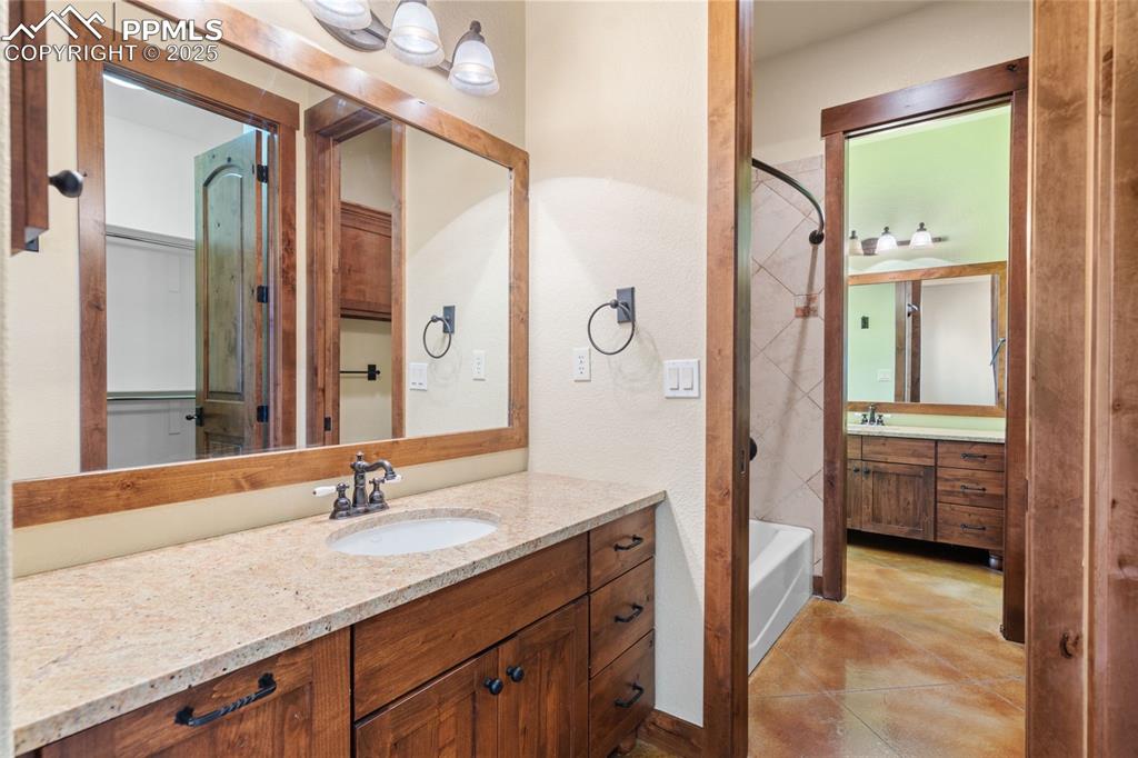 Image 46 of 50: This well-appointed Jack-and-Jill bath adjoins basement bedrooms 3 and 4.