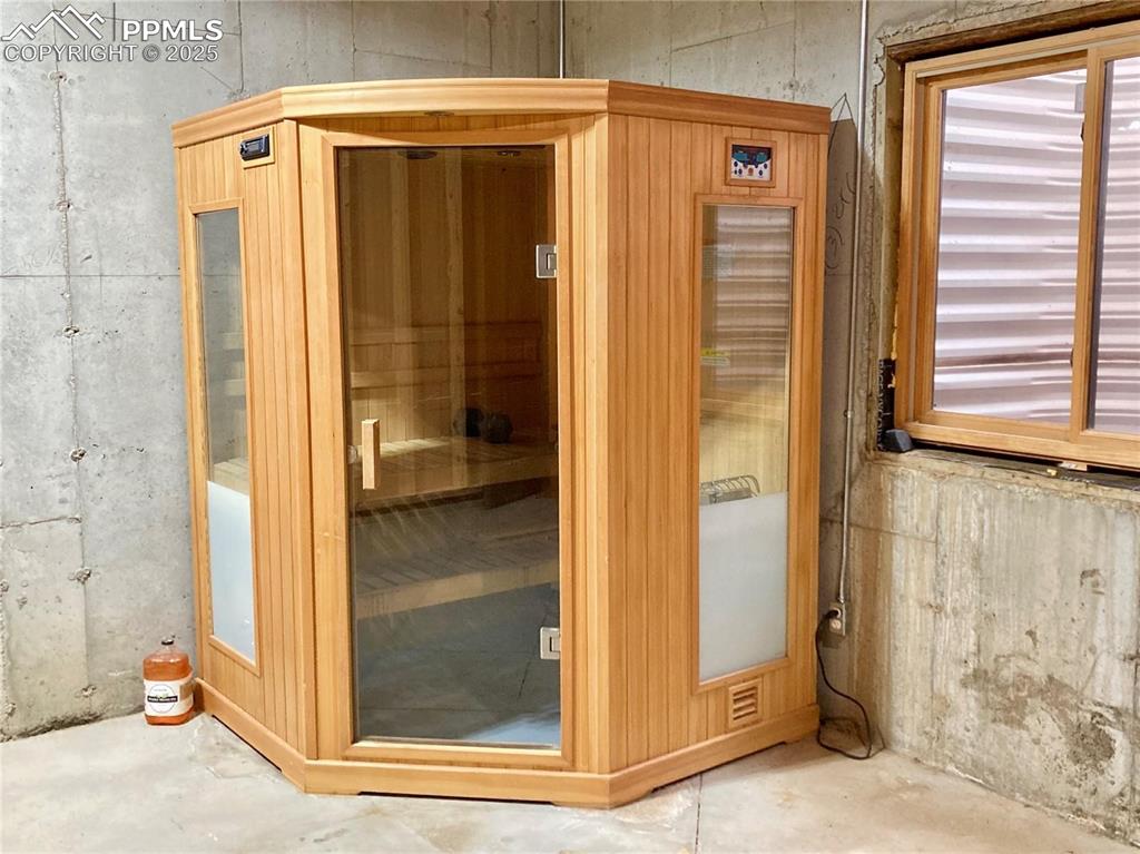 Image 48 of 50: This sauna is located in the basement storage room and it