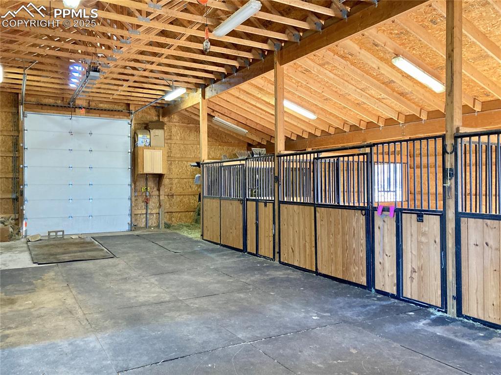 Image 6 of 50: 3 stalls with a 4th currently used as storage. Separate tack room / office