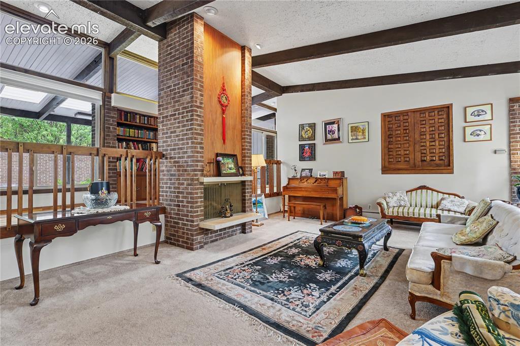Image 20 of 50: Brick fireplace with light stone hearth and wood paneling