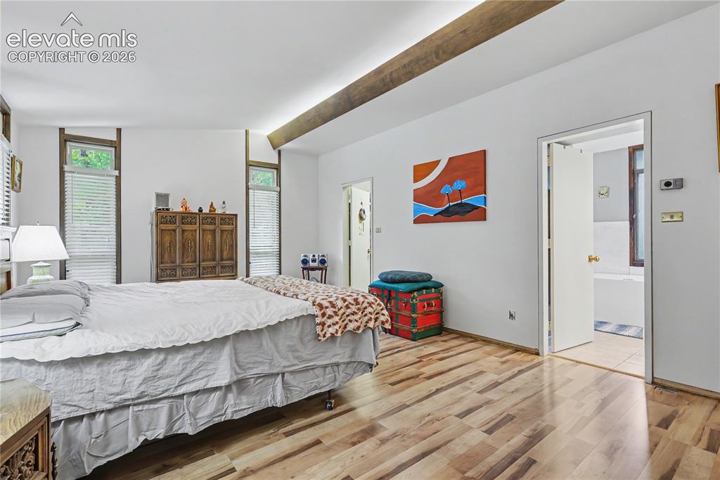 Image 32 of 50: Vaulted ceiling with an exposed wood beam