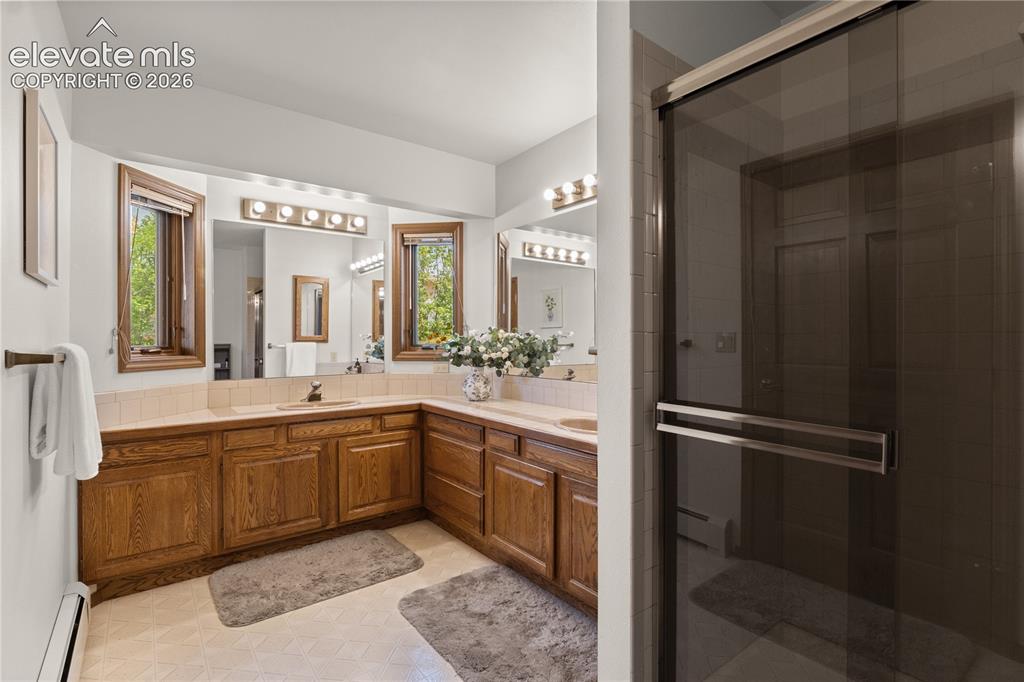 Image 19 of 30: Master bathroom is spacious and bright.