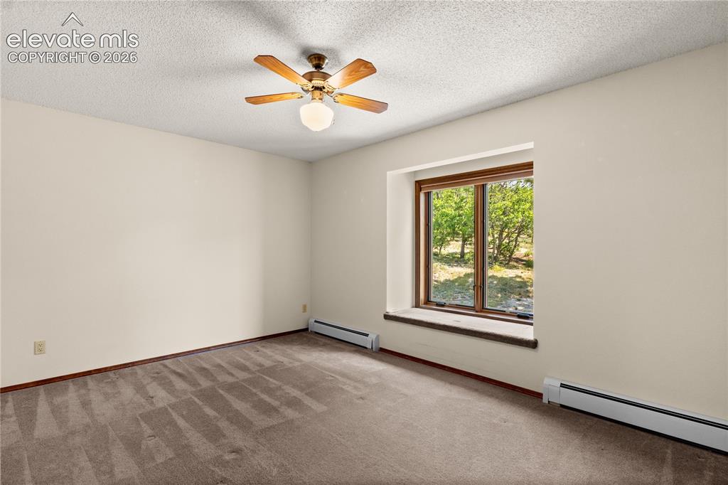 Image 20 of 30: Upper level bedroom isbright and spacious.