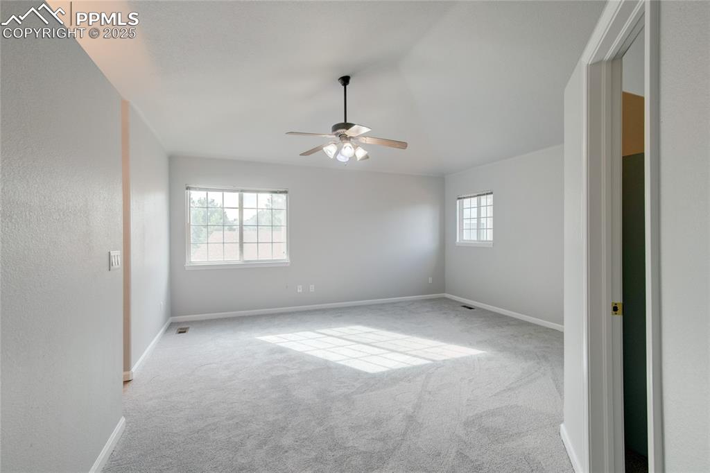 Image 12 of 23: Spare room featuring carpet floors, ceiling fan, and lofted ceiling