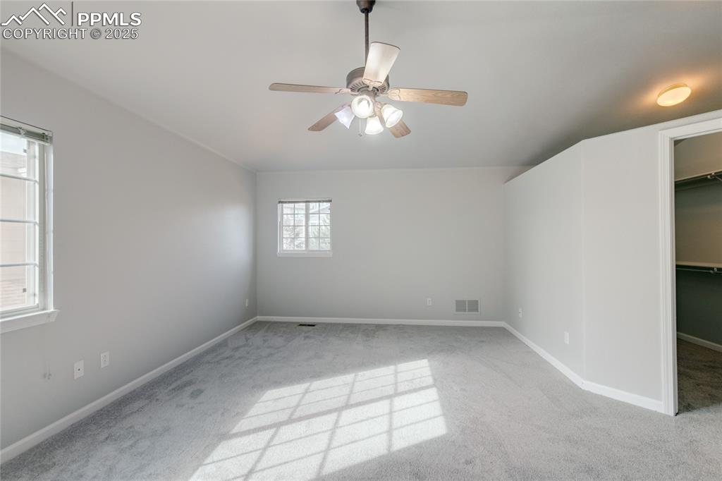 Image 13 of 23: Unfurnished bedroom featuring carpet floors, a walk in closet, and ceiling