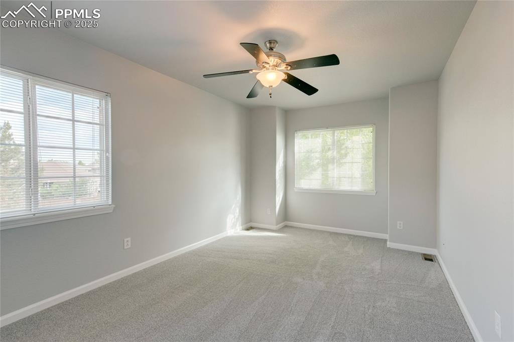 Image 17 of 23: Unfurnished room with light carpet and a ceiling fan