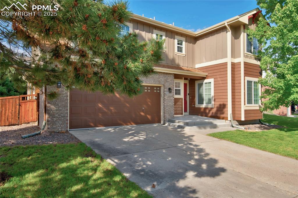 Image 2 of 23: View of front of home featuring driveway, board and batten siding, and an a