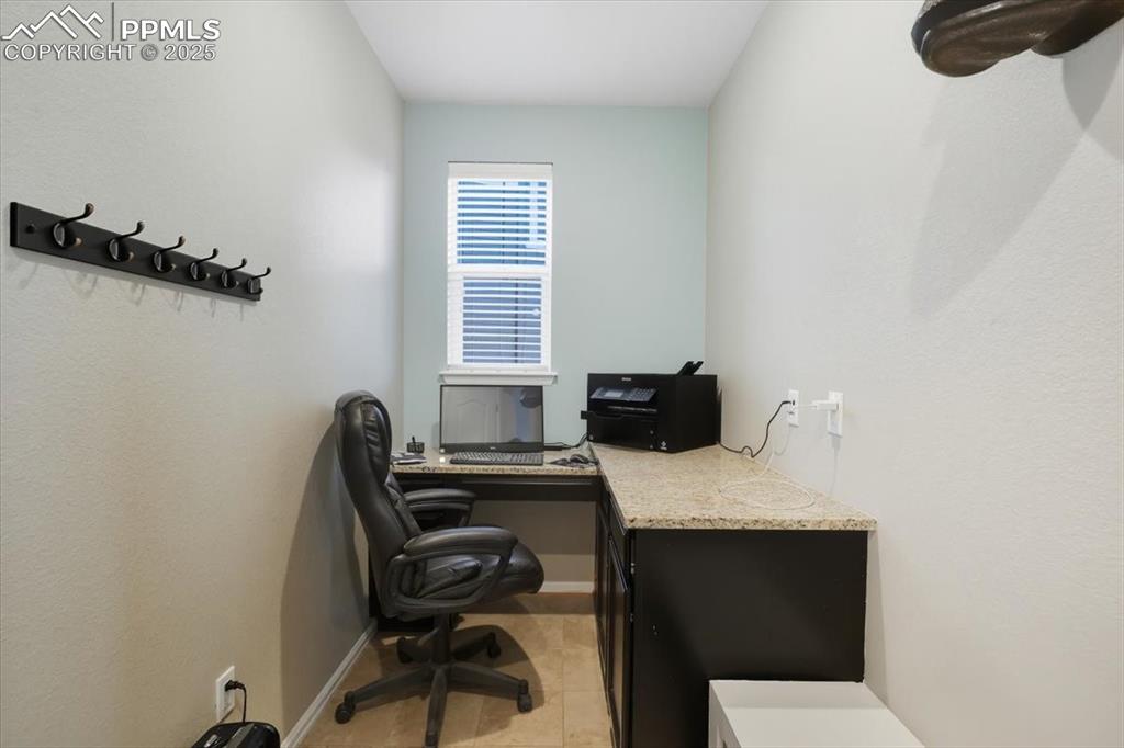 Image 14 of 35: Office space featuring light tile patterned floors and baseboards