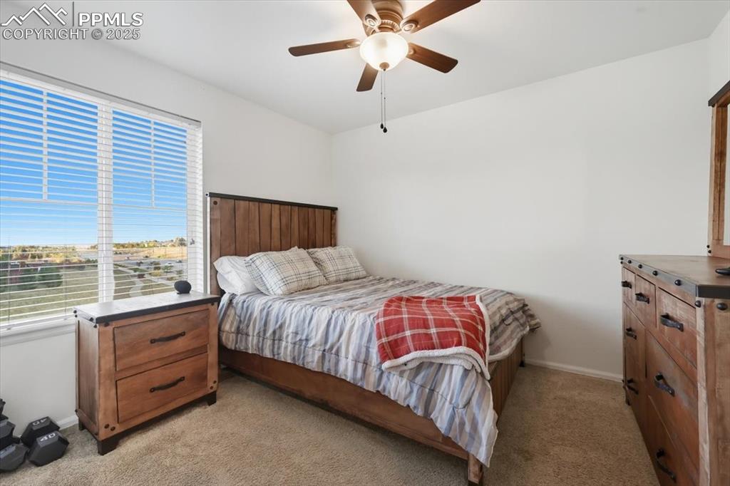 Image 18 of 35: Bedroom featuring a ceiling fan and light colored carpet