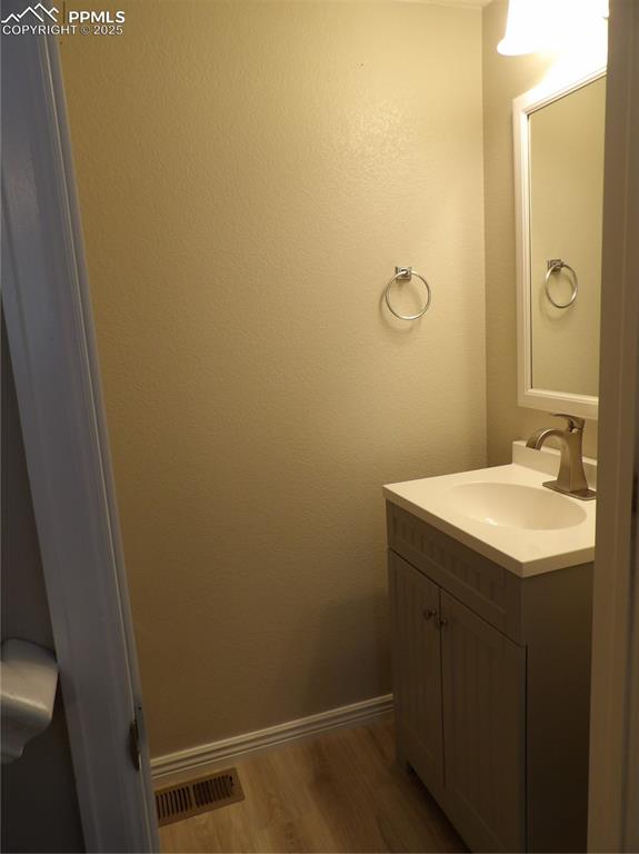 Image 12 of 23: Bathroom featuring vanity and wood finished floors