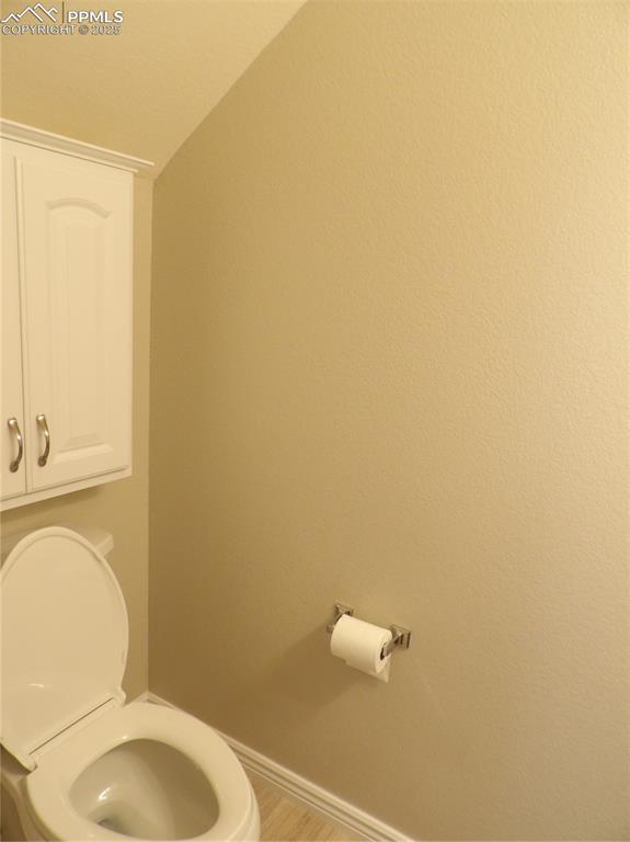 Image 13 of 23: Bathroom featuring toilet and vaulted ceiling