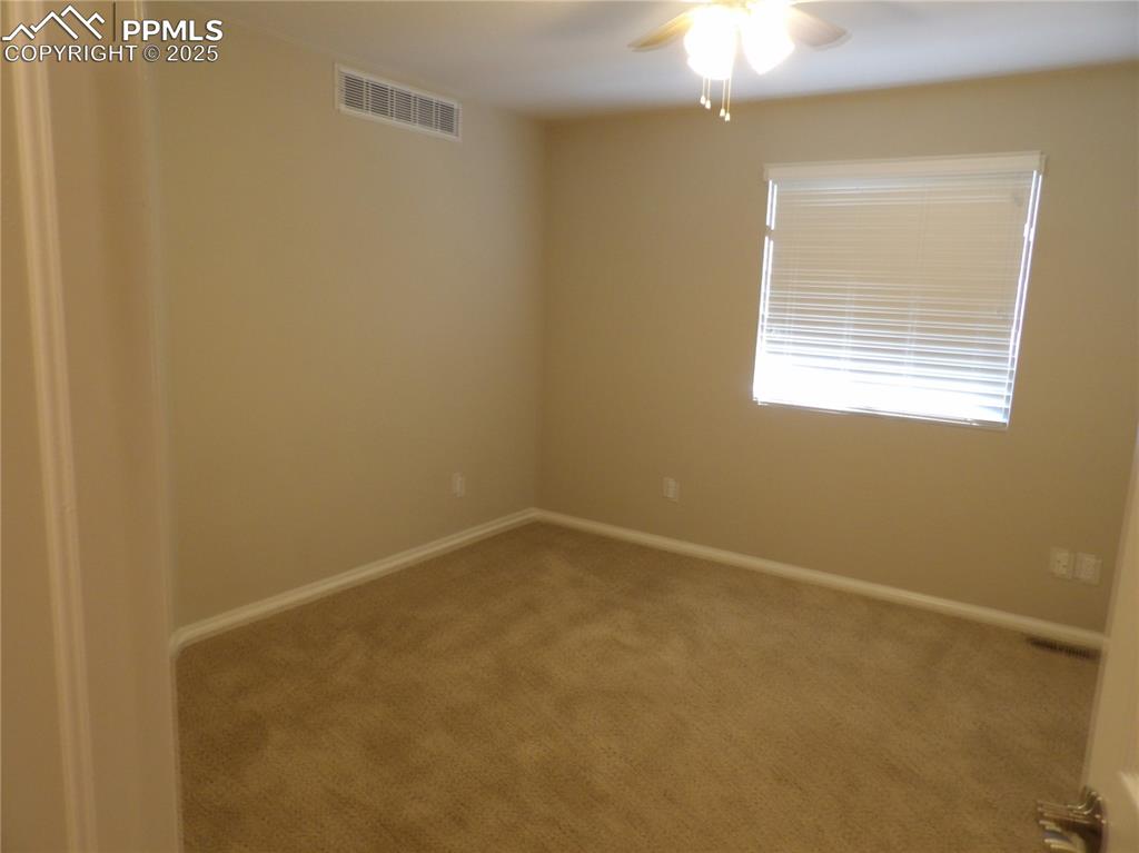 Image 17 of 23: Carpeted empty room with a ceiling fan and baseboards