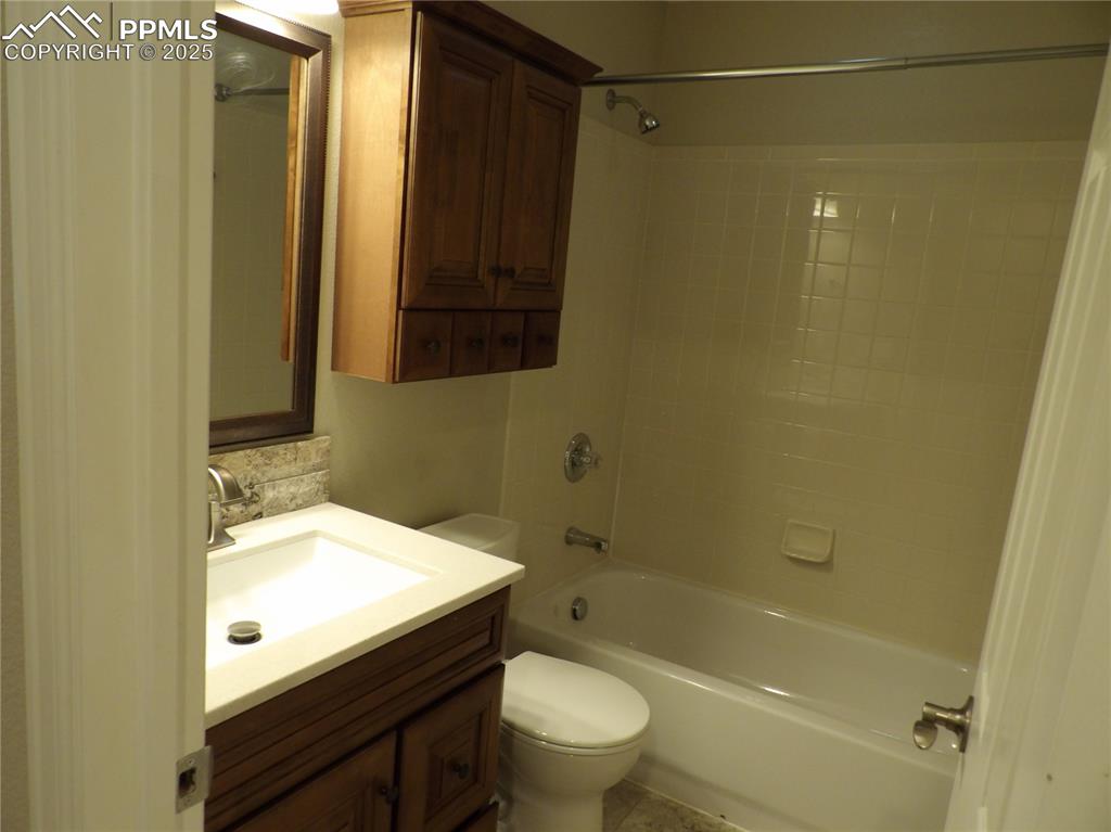Image 18 of 23: Bathroom with vanity and shower / washtub combination