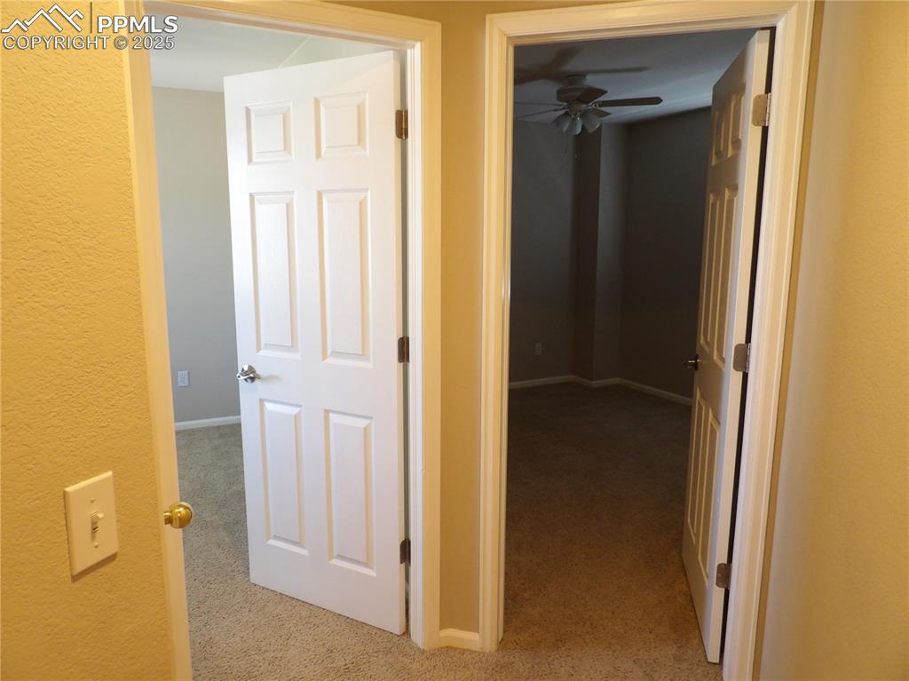 Image 20 of 23: Hall featuring carpet flooring and baseboards