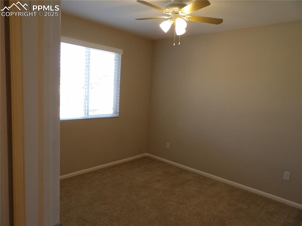 Image 21 of 23: Spare room with carpet and a ceiling fan