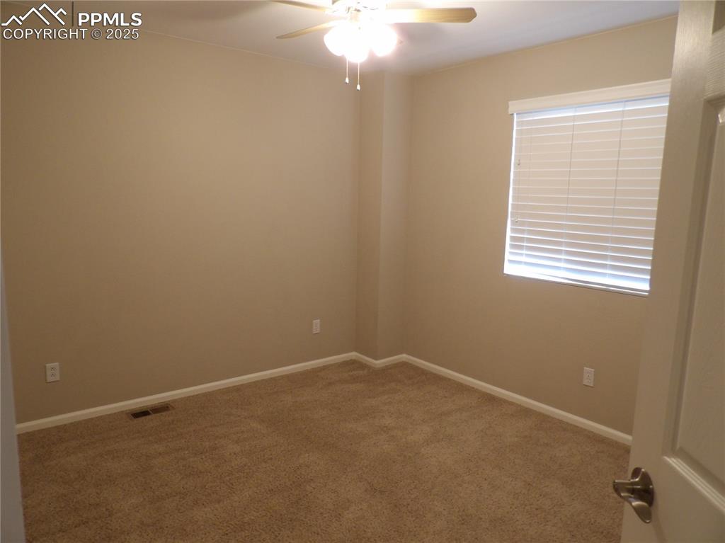Image 22 of 23: Carpeted spare room featuring ceiling fan and baseboards