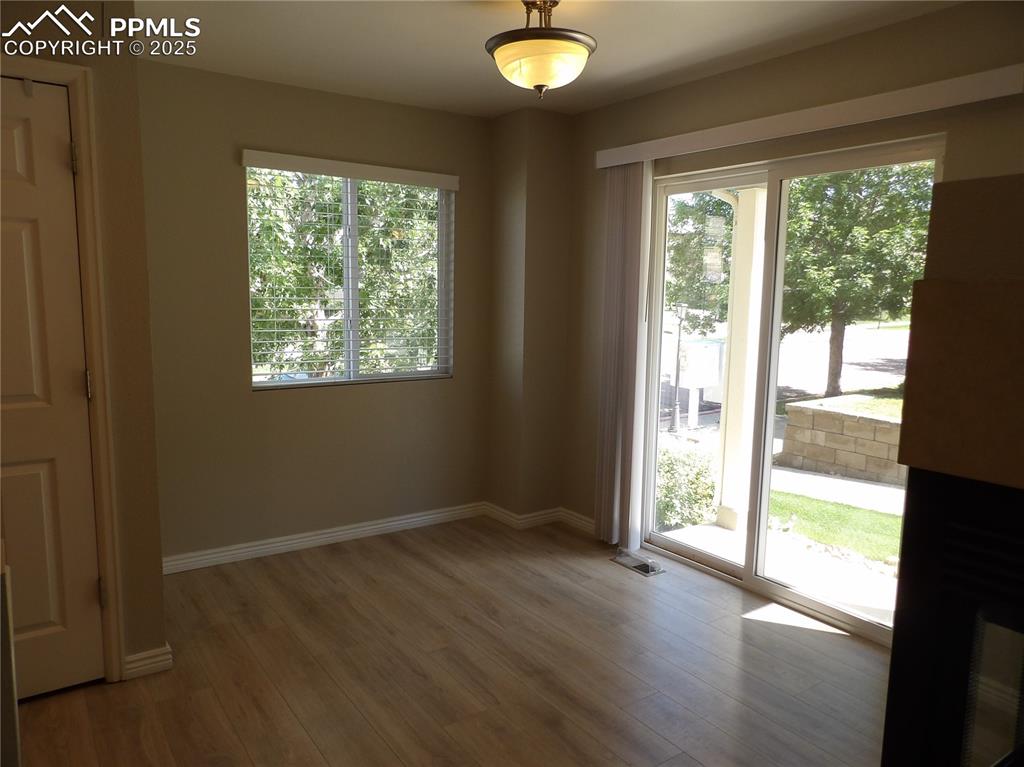 Image 5 of 23: Unfurnished room with wood finished floors and baseboards