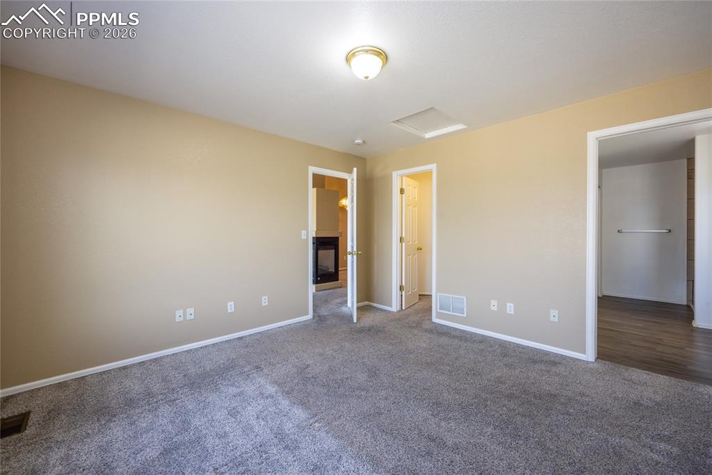 Image 16 of 25: Carpeted interior space featuring a ceiling-mounted light fixture, neutral 
