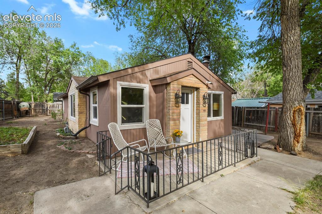 Image 1 of 39: Front of the home with front patio and yard that wraps around